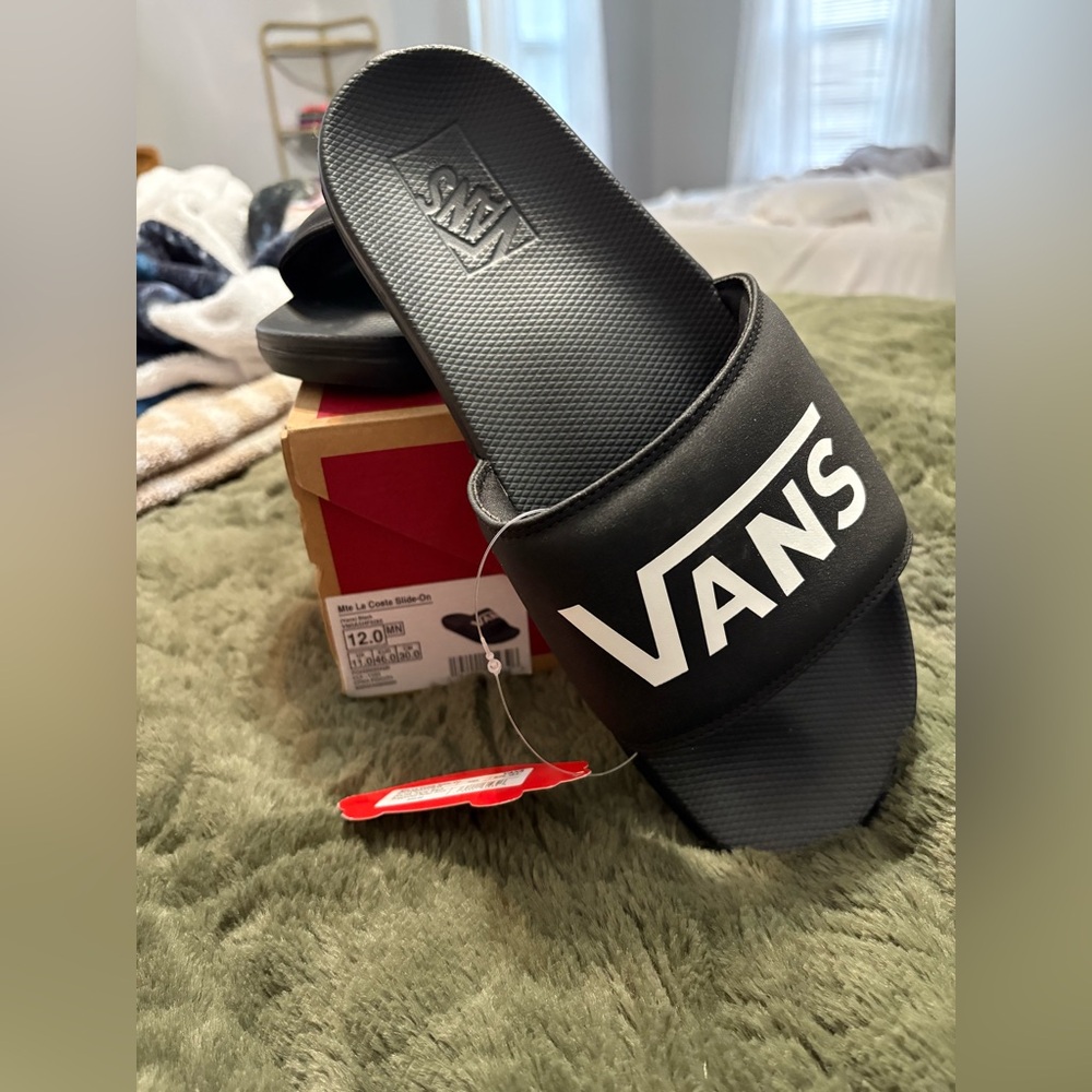 BNIB Men’s black with white lettering Vans slides. Size 12